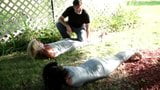 Two girls duct tape mummies outdoors snapshot 9