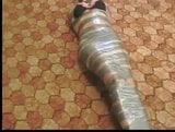 Tape mummified girl with bare feet taped snapshot 1